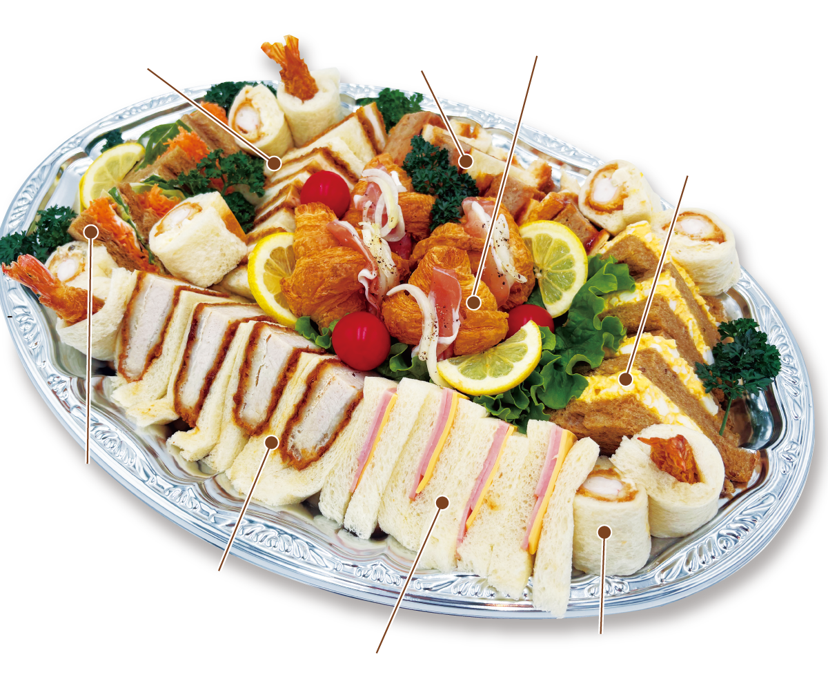 Platter of assorted finger sandwiches and hors d'oeuvres on a decorative silver tray, garnished with lemon slices and greens.