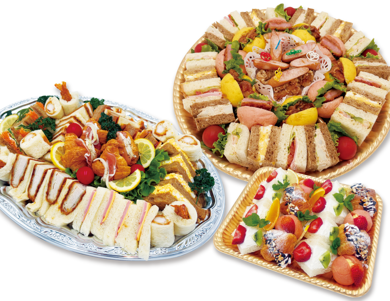 Three large serving trays of party foods: assorted finger sandwiches, wraps, croissants, sausages, and fresh greens arranged with lemon slices.